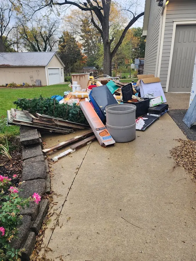 Dumpster being loaded with debris for Estate Cleanout Dumpster Rental in Scottsboro